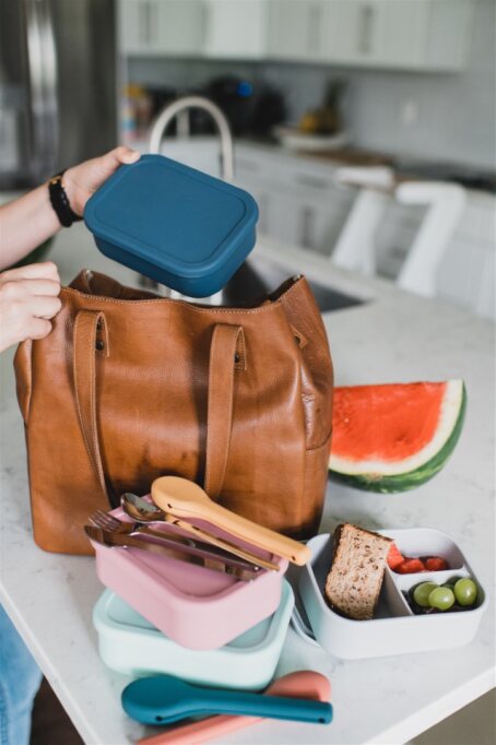 Bento Boxes and travel utensil sets being put into purse.