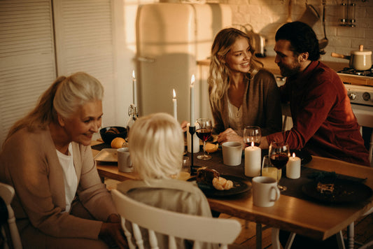 Family having dinner at kitchen table with candles
